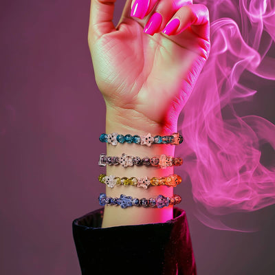 NOGU Halloween Kitsch beaded bracelets in neon blue, pink, yellow and purple with skull accents on a wrist.