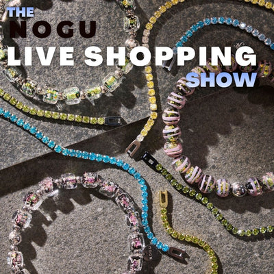 NOGU Live Show collection featuring colorful crystal tennis necklaces and pastel beaded bracelets on textured stone.