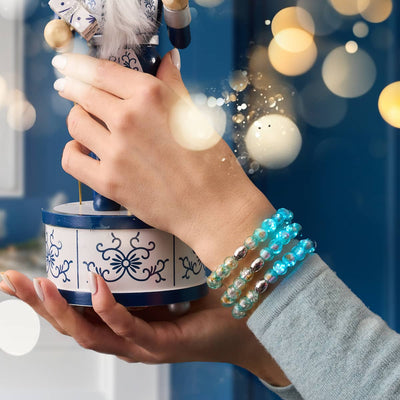 NOGU Ugly Christmas Sweater Edition stack of turquoise glass bead bracelets with silver accents for festive holiday styling.