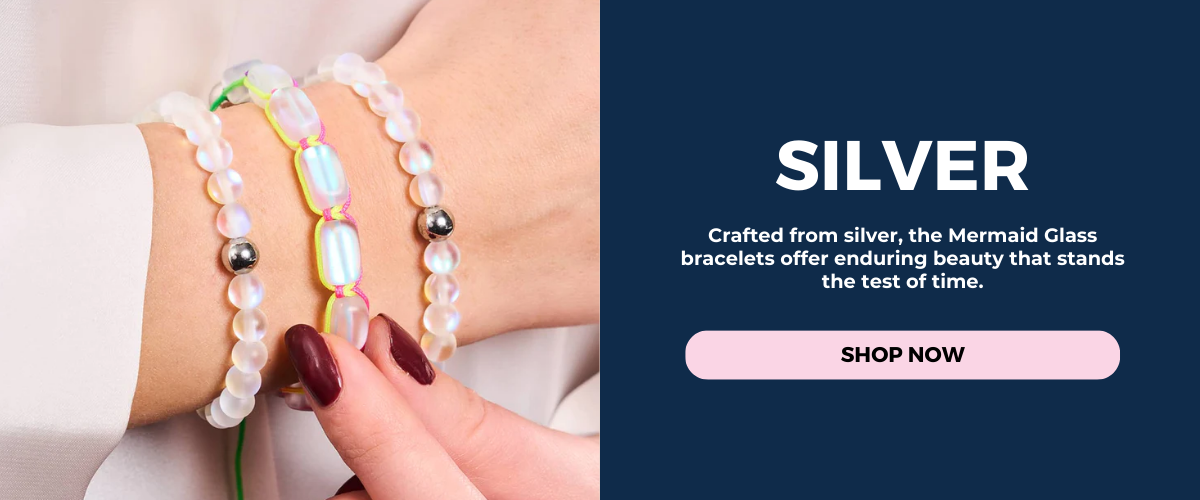 NOGU Mermaid Glass silver bracelet stack with iridescent white beads, silver accents, and neon cord details on wrist.