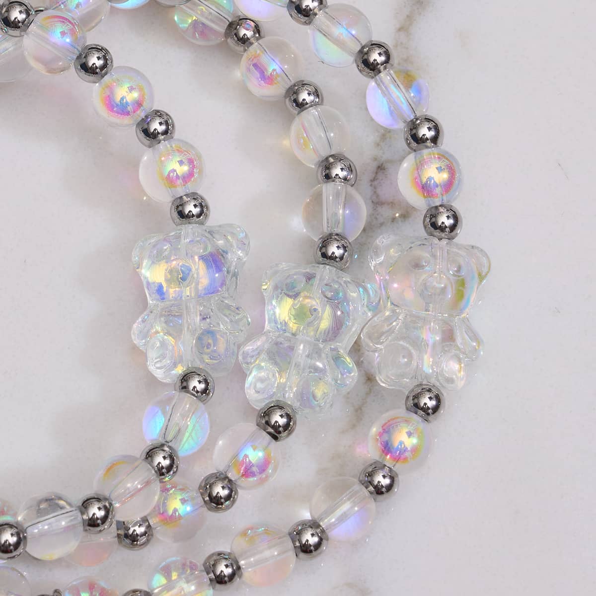 Unicorn White double shimmer bear bracelet close-up with iridescent crystal beads and silver spacer beads by NOGU