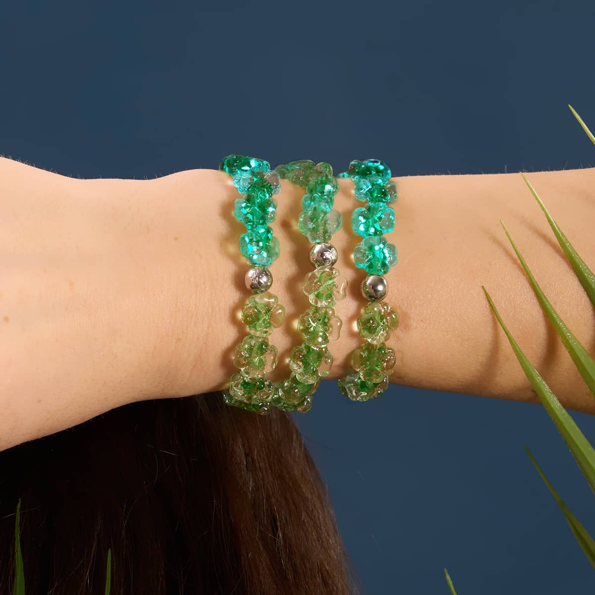 Luminous Shamrock bracelets with green Firefly Glass clover beads and silver-plated stainless steel worn on wrist by NOGU