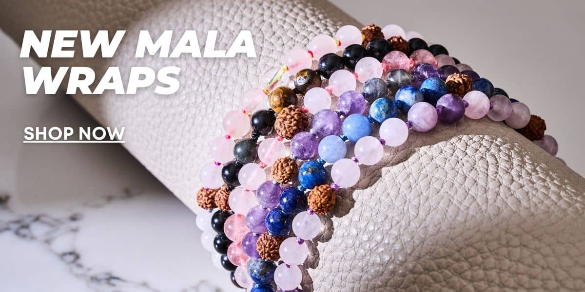 NOGU Mala Wraps with colorful gemstone beads and textured brown seed beads wrapped around a soft gray cushion.