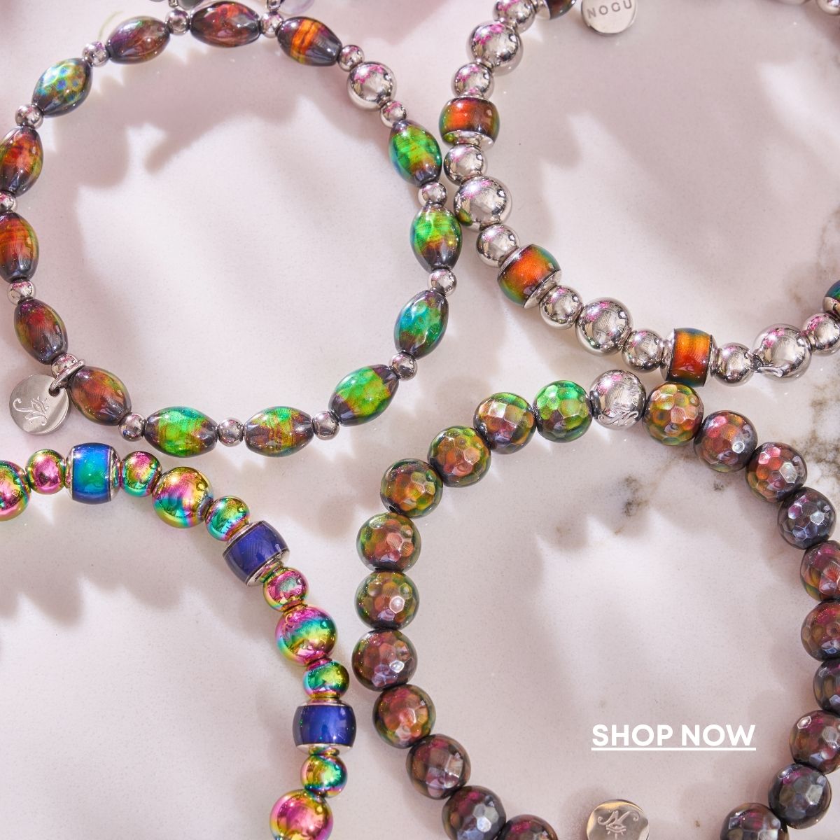 NOGU Pool Party beaded bracelets with iridescent multicolor glass beads and polished silver-tone accents.