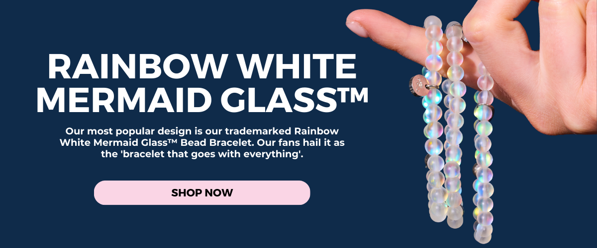 NOGU Rainbow White Mermaid Glass bead bracelet with iridescent translucent white beads, shown draped over a hand.