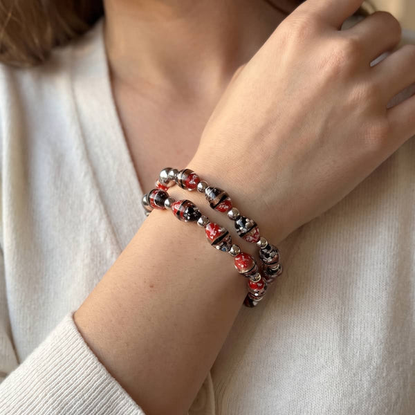 Crimson Current tiger glass oval bracelet with red, black and white marbled beads and silver stainless steel accents.