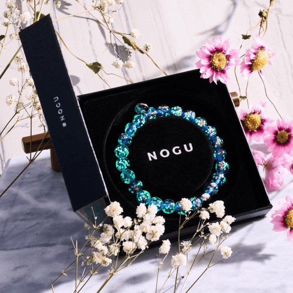 Sapphire Firefly Glass Bracelet with glowing blue and green lampwork beads and .925 sterling silver bead in black NOGU box with flowers